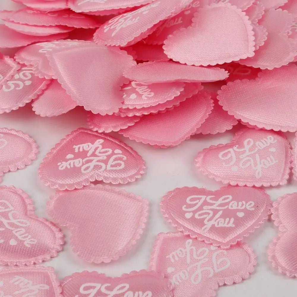 Pink heart-shaped sponge confetti scattered on a white surface for weddings and celebrations
