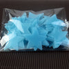 A clear plastic bag filled with a pack of light blue glow-in-the-dark star wall stickers.