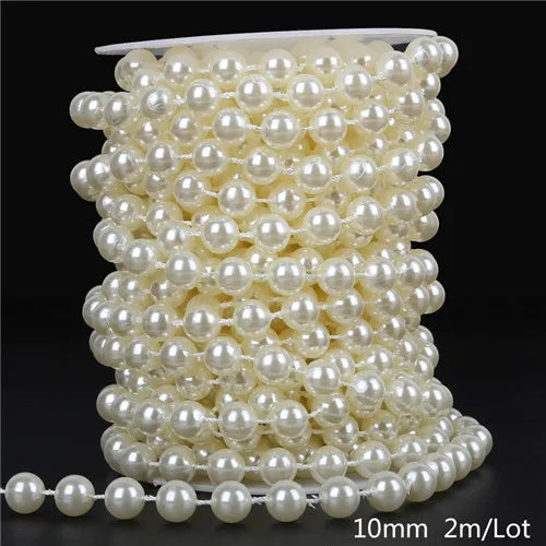 A spool of ivory pearl beads used for garland decoration, showing the beads coiled and a finished strand.