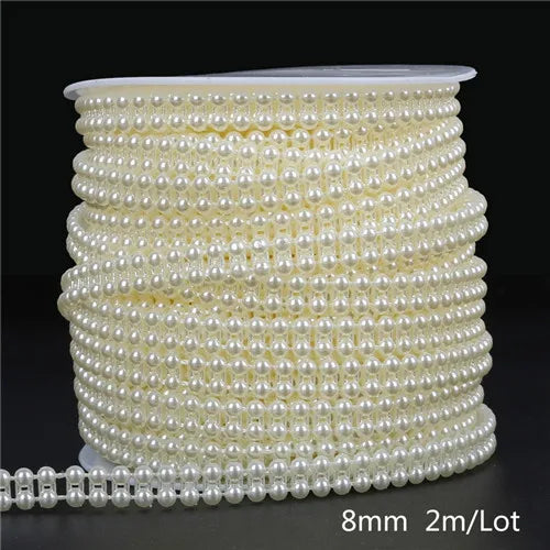A spool of ivory pearl bead garland, measuring 2 meters per lot, used for wedding and event decoration.