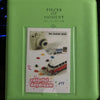 A lime green compact photo album titled Pieces of Moment featuring a colorful daydream theme.