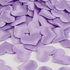 Purple heart-shaped sponge confetti scattered on a white surface for weddings and celebrations