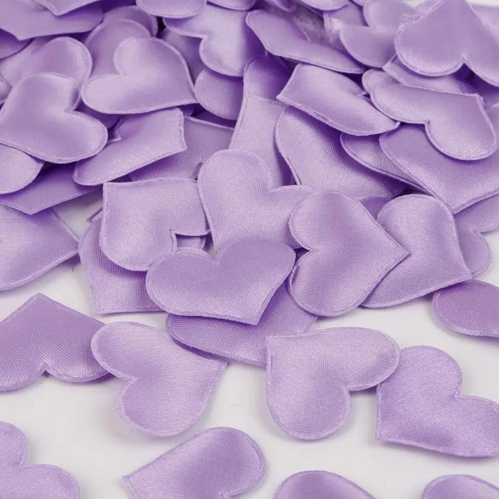 Purple heart-shaped sponge confetti scattered on a white surface for weddings and celebrations
