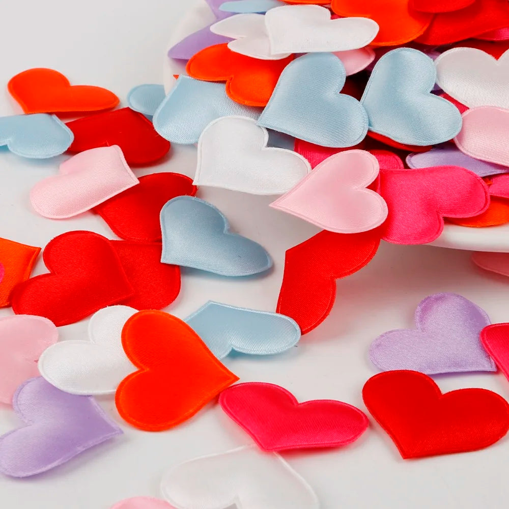 A close-up of heart-shaped colored sponge confetti in various shades of red, pink, blue, and purple.