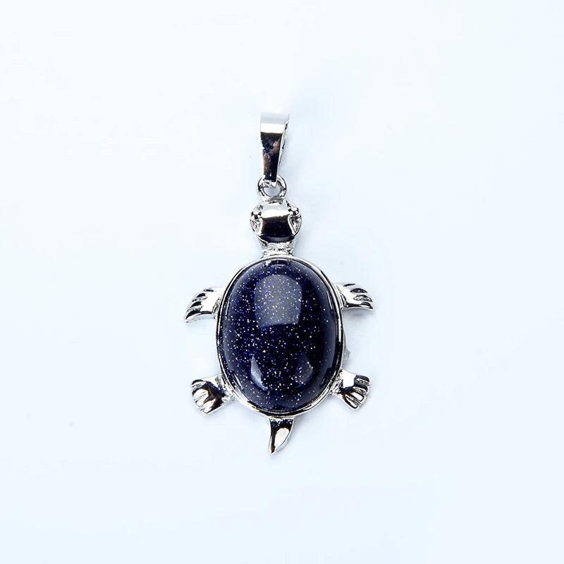 Silver pendant necklace featuring a polished dark blue stone shaped like an animal.
