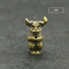 Brass statue of a horned animal head with an incense holder, displayed on a dark surface.
