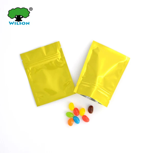 Yellow foil zip bags containing colorful candies are displayed on a white background.