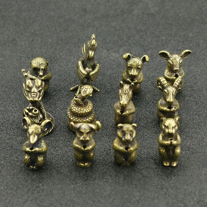 A collection of small brass statues depicting various Chinese Zodiac animals, used as incense holders.