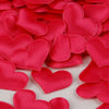Red heart-shaped sponge confetti scattered on a white background for weddings and celebrations