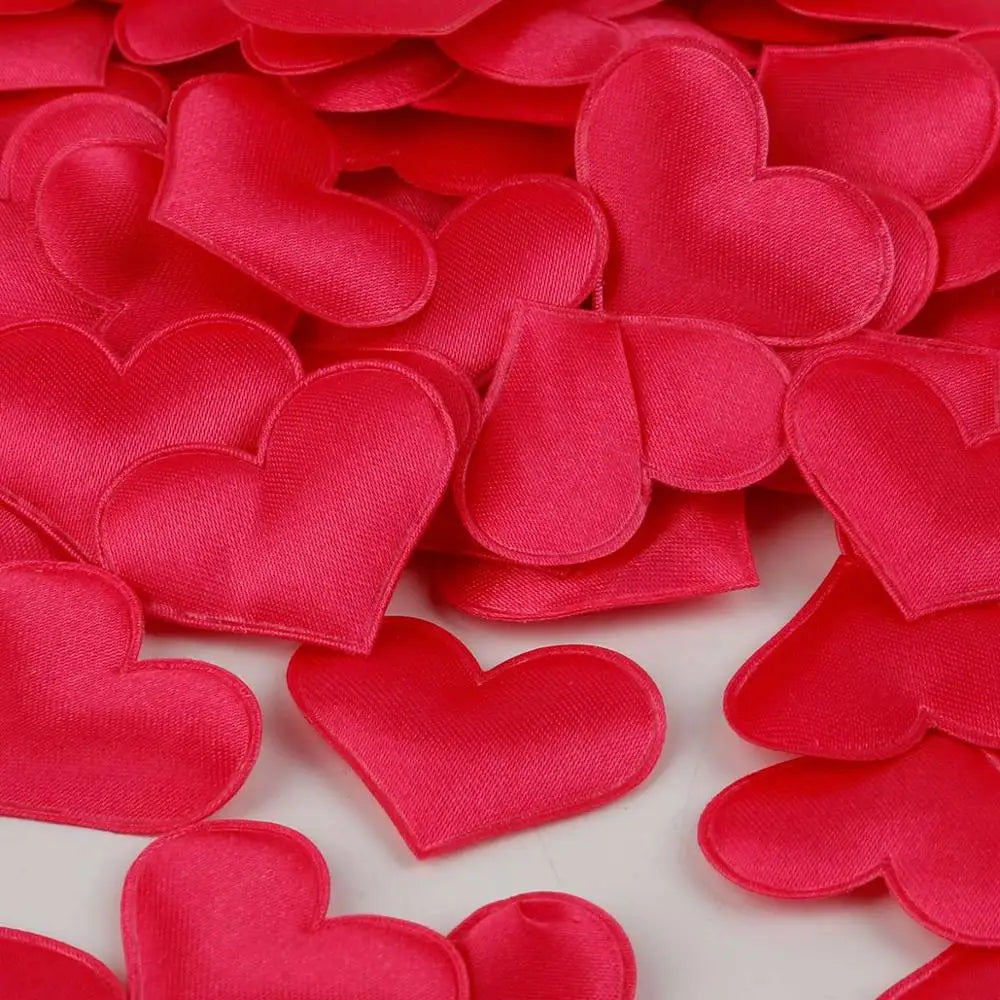 Red heart-shaped sponge confetti scattered on a white background for weddings and celebrations