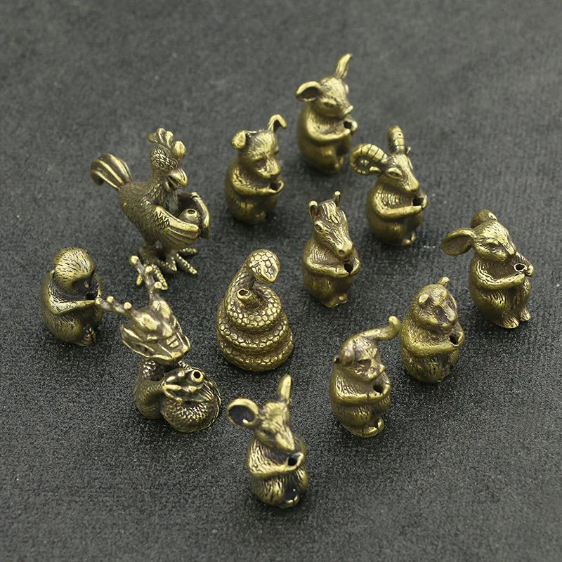 A collection of small brass statues depicting various Chinese Zodiac animals, used as incense holders.
