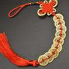 A necklace featuring an I Ching copper coin charm with a handwoven knot and red cord.