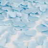 Light blue heart-shaped sponge confetti scattered on a white surface.