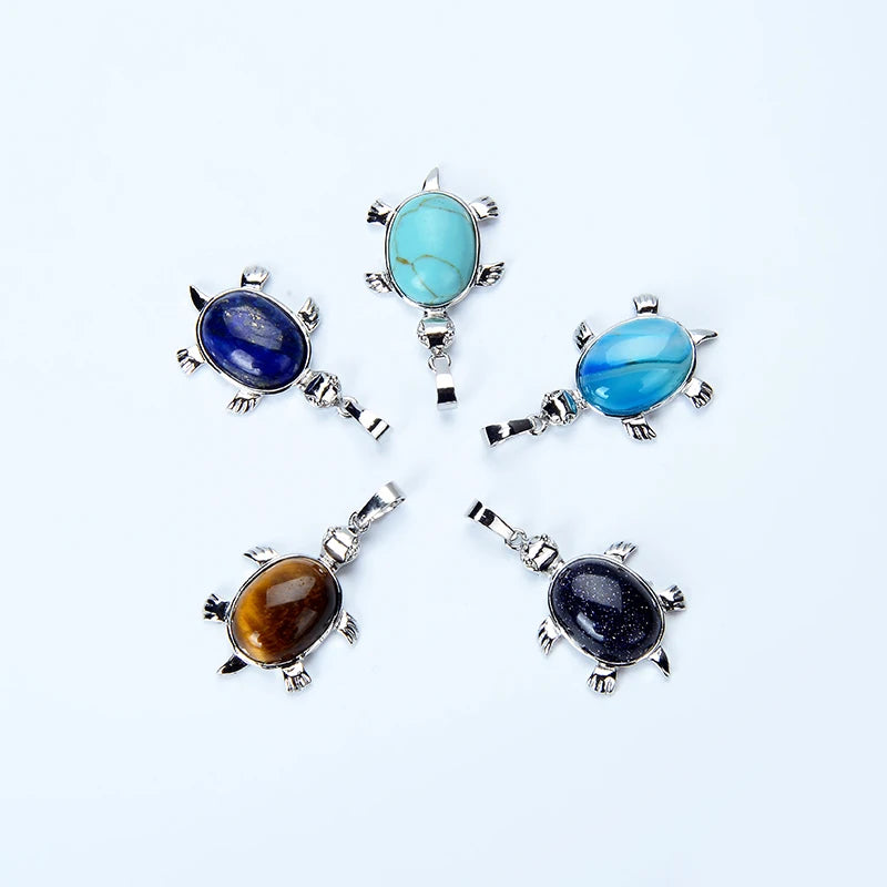 A collection of four natural stone animal pendant necklaces featuring blue and amber stones set in silver findings.