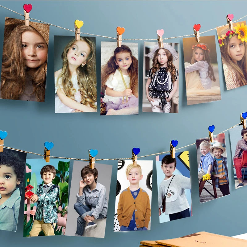 A string of natural wooden clips displaying various photos of children and adults for crafts and decor