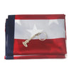 A folded red, white, and blue American flag banner with a gold-colored replica firearm displayed on the fabric.