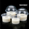 Five clear disposable dessert cups with lids containing a white creamy substance, packaged for serving.