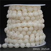 A spool of ivory pearl beads used for garland decoration, packaged with a size label.