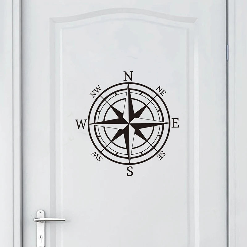 A black nautical compass rose design centered on a white door panel.
