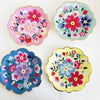 A set of five colorful floral disposable plates featuring pink, blue, and red flowers on white and pastel backgrounds.