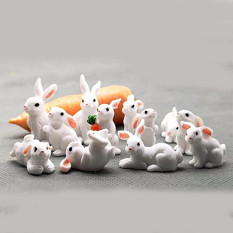 A collection of small white rabbit figurines arranged around an orange carrot.