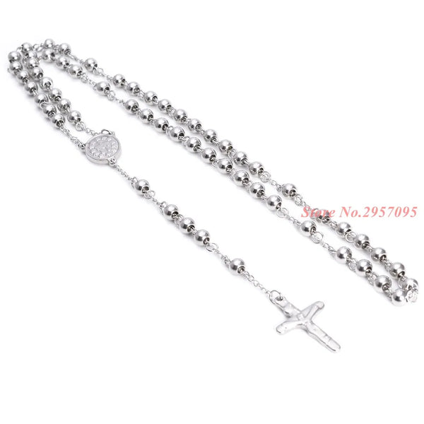 A silver stainless steel cross pendant necklace with a chain and a small circular charm.