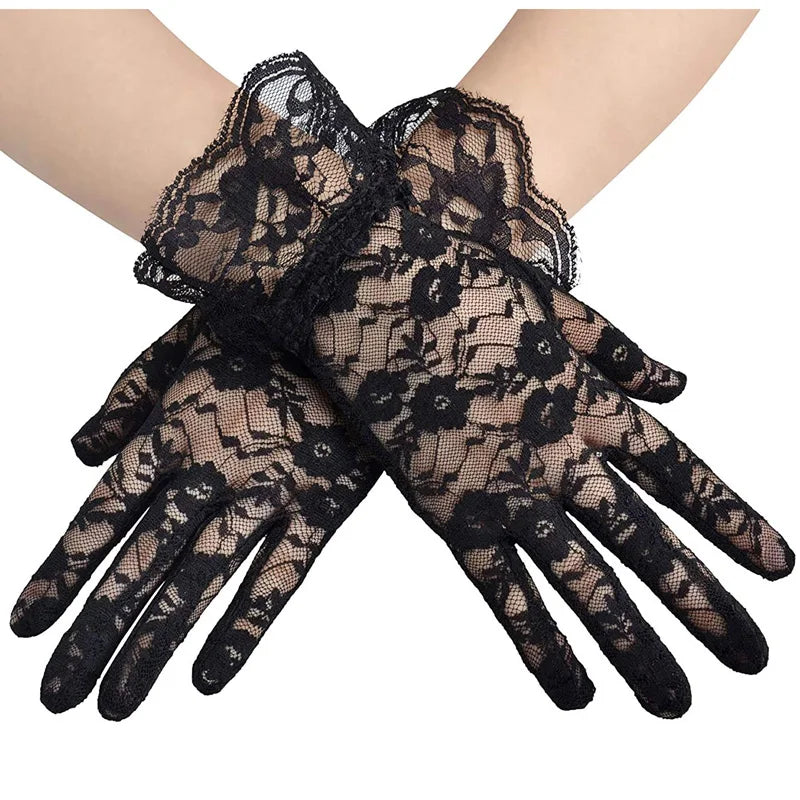 Black sheer lace gloves worn on a hand, showing intricate floral patterns.