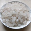 A pile of white natural unrefined sea salt crystals in a white dish.
