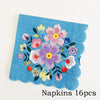 A teal napkin featuring a colorful floral pattern of pink, purple, and yellow flowers.