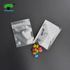 Clear foil zip bags containing colorful candies are displayed on a dark surface.
