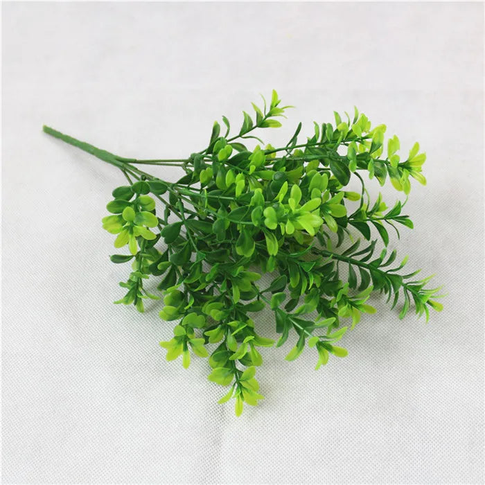 Green artificial fern and leaf sprigs used for home decor