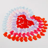 A circular arrangement of heart-shaped sponge confetti in various pastel and bright colors like pink, purple, blue, and red.