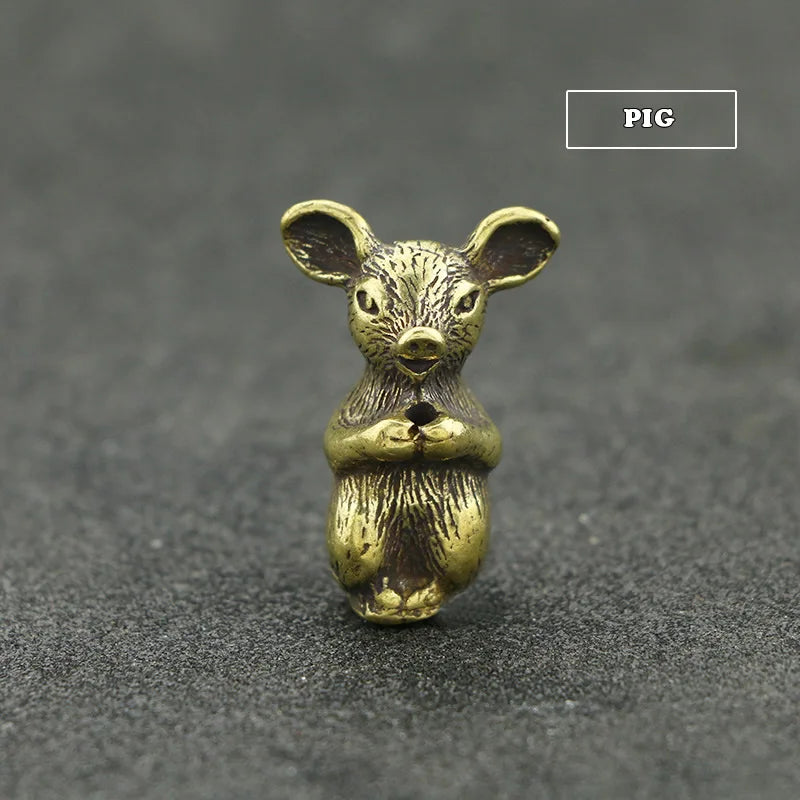A small brass statue of a rodent animal with large ears, used as an incense holder.