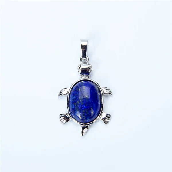 A silver pendant necklace featuring a deep blue natural stone shaped like an animal.