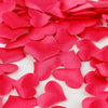 Pink heart-shaped sponge confetti scattered on a white background for weddings and celebrations