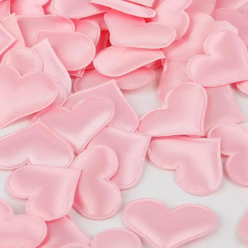 Pink heart-shaped sponge confetti scattered on a white background for weddings and celebrations