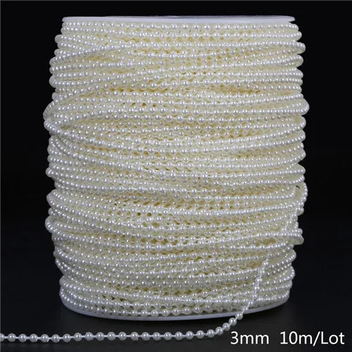 A spool of ivory pearl beads, measuring 3mm and 10 meters per lot, stacked in a cylindrical shape.