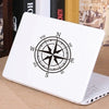 A white laptop featuring a black nautical compass rose design on the lid.