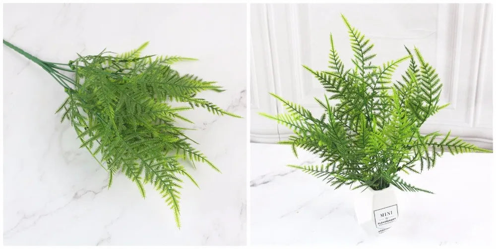 A sprig of bright green artificial fern leaves displayed on a white marble surface.