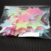 A clear plastic bag filled with a 50 pack of glow-in-the-dark star wall stickers in various shades of pink and light green.