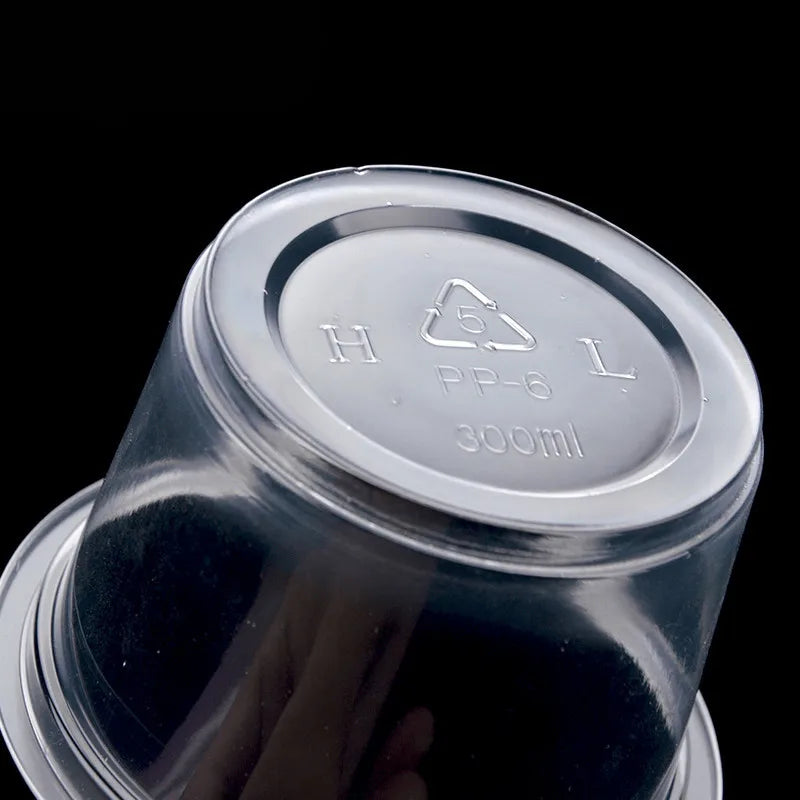 Clear plastic disposable dessert cups with lids labeled PP-6 and 300ml capacity