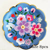 A blue floral disposable plate with pink and white flowers and gold rim.