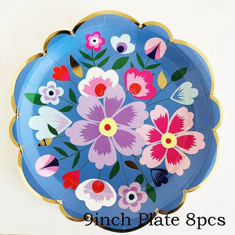 A blue floral disposable plate with pink and white flowers and gold rim.