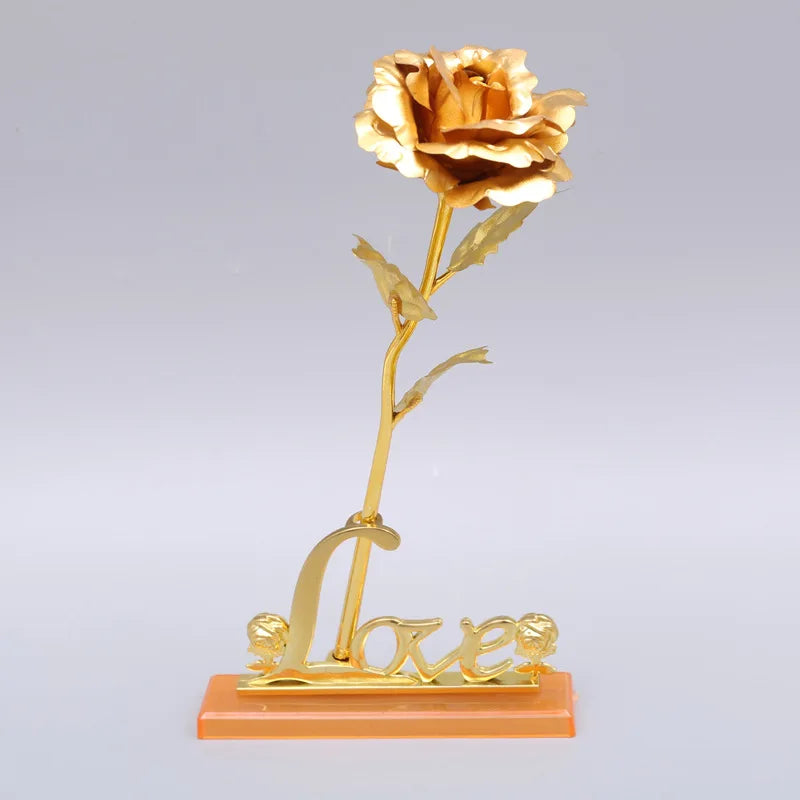 A gold foil artificial rose bouquet mounted on a stand, featuring the word Love.