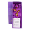 A purple box containing a gold foil artificial rose and a test report card.