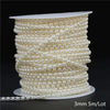 A spool of ivory pearl beads, approximately 3mm in size, coiled for garland decoration.