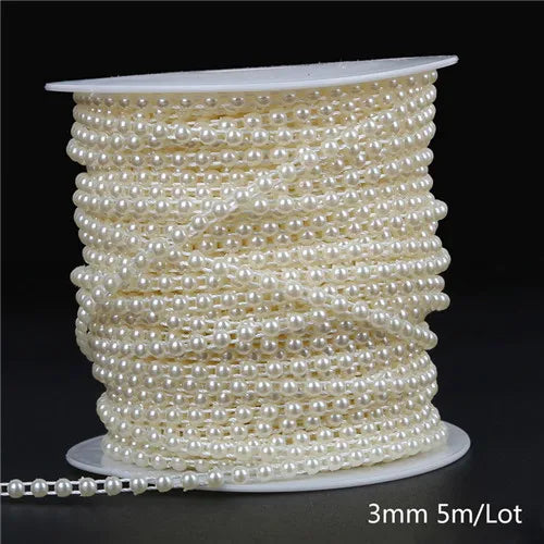 A spool of ivory pearl beads, approximately 3mm in size, coiled for garland decoration.