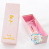 A pink box containing a 24K Golden Rose artificial rose bouquet with gold foil accents.