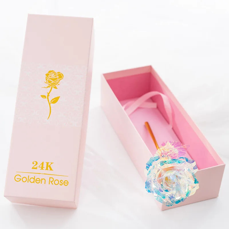 A pink box containing a 24K Golden Rose artificial rose bouquet with gold foil accents.