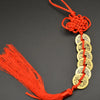 Orange thread charm featuring a copper coin and handwoven knot for Feng Shui